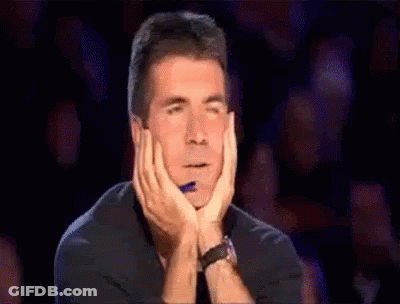 Man Sitting Hands On Chin In Crowd GIF