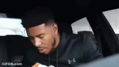 Man Sitting In Back Seat Eating Burger GIF
