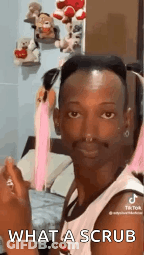 Man Sitting In Bedroom Holding Perfume Making Face GIF