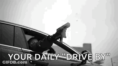 Man Sitting In Car Head Out Window Holding Gun GIF