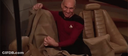 Man Sitting In Car Holding Blanket GIF
