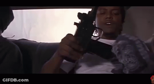 Man Sitting In Car Holding Gun GIF