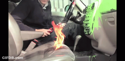 Man Sitting In Car Holding Scissors With Flame GIF
