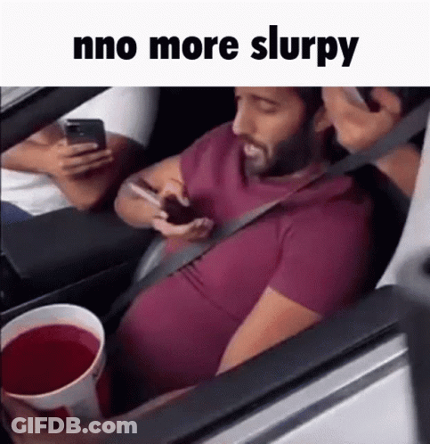 Man Sitting In Car On Phone Holding Red Drink GIF