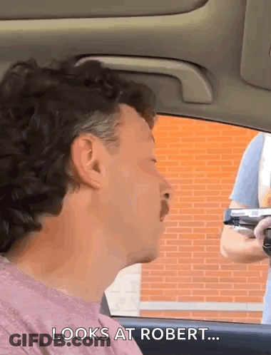 Man Sitting In Car Watching Gun GIF