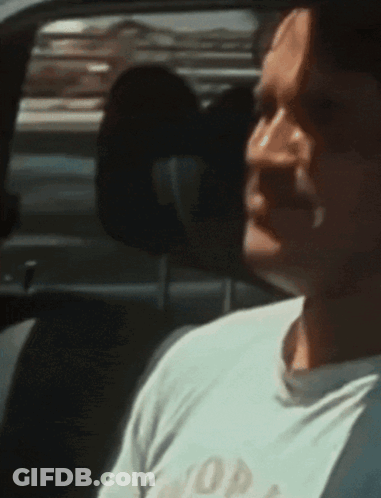 Man Sitting In Car Wearing White Shirt Saying Hop GIF