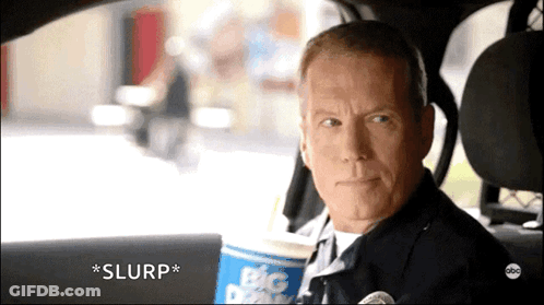 Man Sitting In Car With Big Dipper Cup GIF