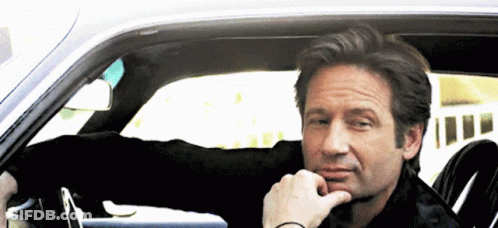 Man Sitting In Car With Hand To Chin GIF