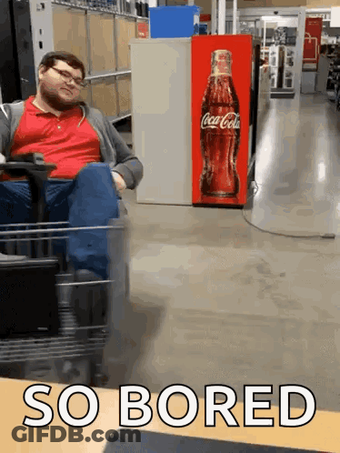 Man Sitting In Cart In Front Of Coca Cola Machine GIF