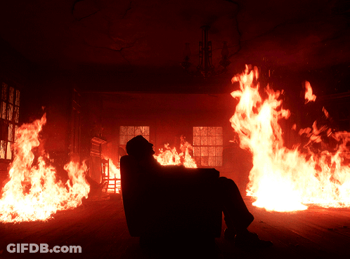 Man Sitting In Chair Before Flames GIF