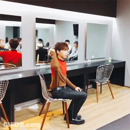 Man Sitting In Chair Before Mirror GIF