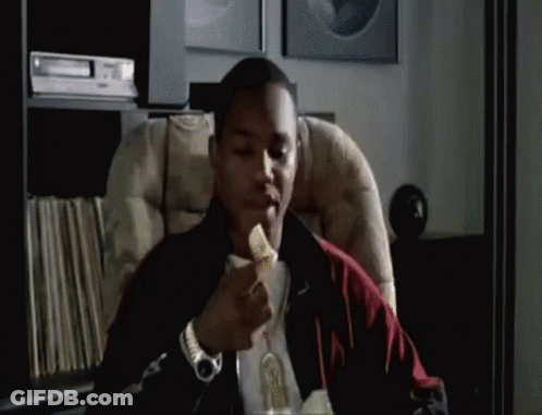 Man Sitting In Chair Eating Pizza GIF