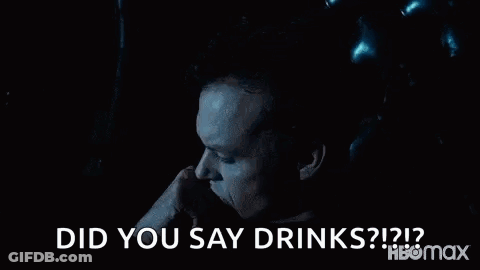 Man Sitting In Chair Hand To Mouth Saying Did You Say Drinks GIF