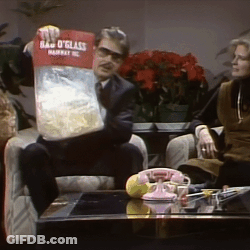 Man Sitting In Chair Holding Bag O Glass GIF