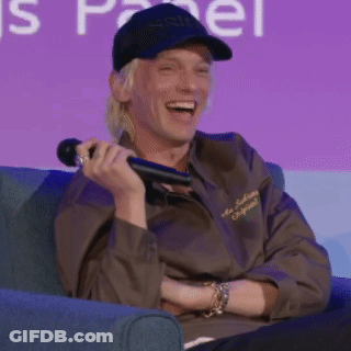 Man Sitting In Chair Holding Microphone Smiling GIF