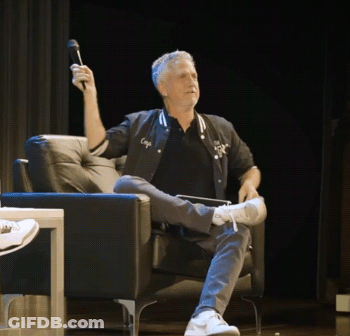 Man Sitting In Chair Holding Microphone GIF