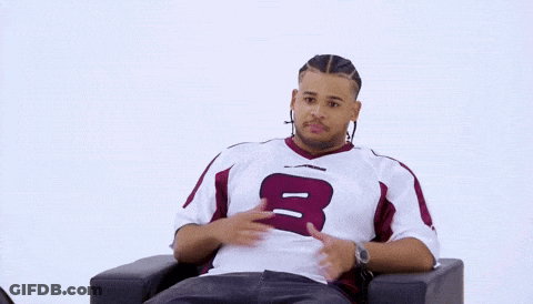 Man Sitting In Chair Holding Sign Saying Fanum GIF