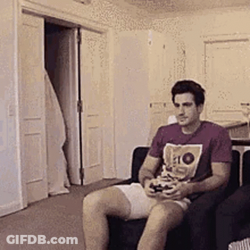 Man Sitting In Chair Holding Video Game Controller GIF