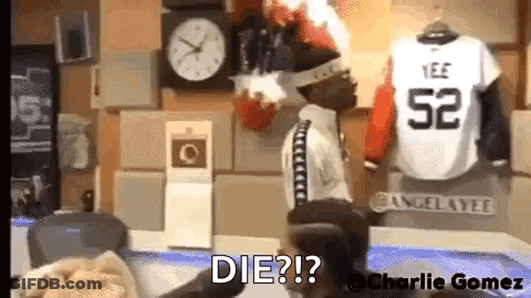 Man Sitting In Chair In Front Of Clock And Jersey Saying Die GIF
