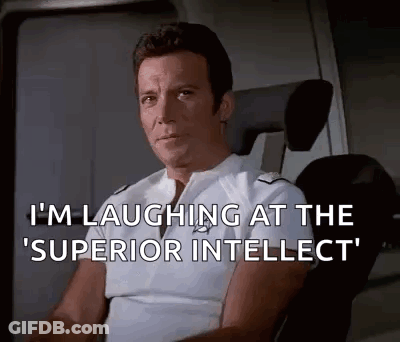 Man Sitting In Chair Laughing At Superior Intellect GIF