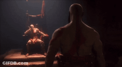 Man Sitting In Chair Looking At Another Man In Dark Room GIF