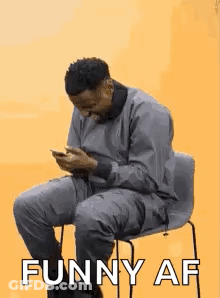 Man Sitting In Chair Looking At Phone Saying Funny AF GIF