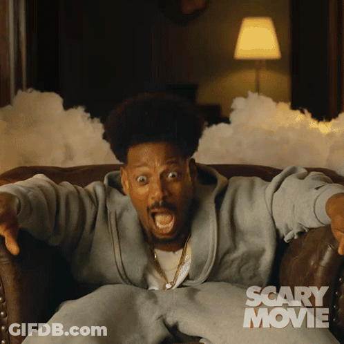 Man Sitting In Chair Saying Scary Movie GIF