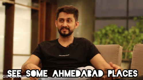 Man Sitting In Chair Saying See Some Ahmedabad Places GIF