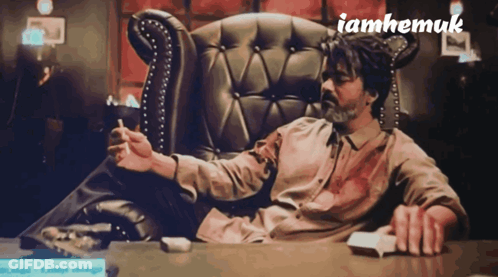 Man Sitting In Chair Smoking Cigarette GIF