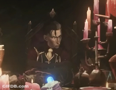 Man Sitting In Chair Surrounded By Candles And Statue GIF
