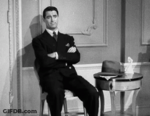 Man Sitting In Chair With Arms Crossed GIF
