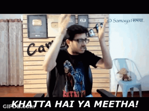 Man Sitting In Chair With Arms In Air Saying Khatta Hai Ya Meetha GIF