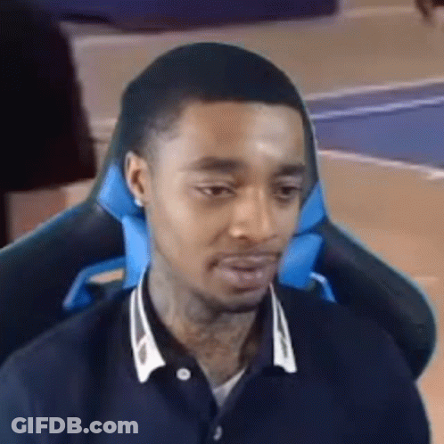 Man Sitting In Chair With Blue Pillow GIF