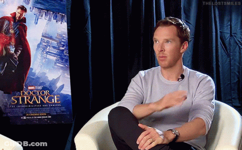 Man Sitting In Chair With Doctor Strange Poster GIF