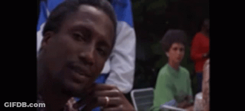 Man Sitting In Chair With Eyes Closed Surrounded By People GIF