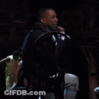 Man Sitting In Chair With Hand Up GIF