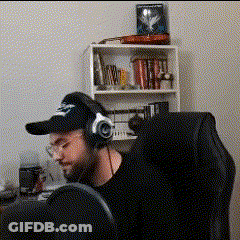 Man Sitting In Chair With Headphones And Baseball Cap GIF