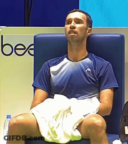 Man Sitting In Chair With Legs Crossed And Towel GIF