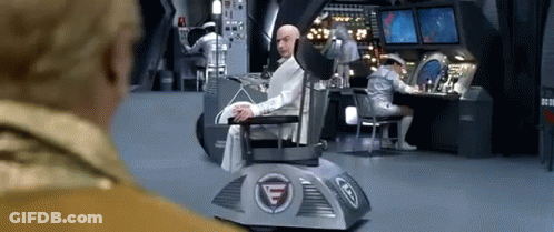 Man Sitting In Chair With Letter G GIF
