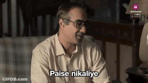 Man Sitting In Chair With Paise Nikalye GIF