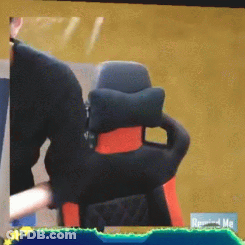 Man Sitting In Chair With Remind Me On Bottom Right GIF