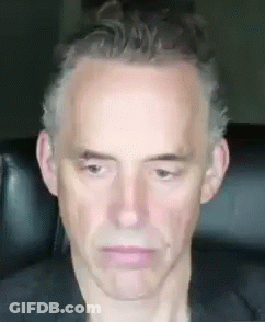 Man Sitting In Chair With Serious Look GIF