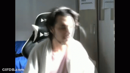 Man Sitting In Chair With Sign Das Pessoas GIF