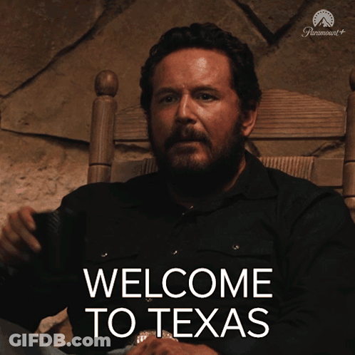 Man Sitting In Chair With Welcome To Texas On Screen GIF