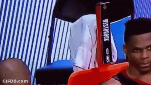 Man Sitting In Chair With Westbrook Sign GIF