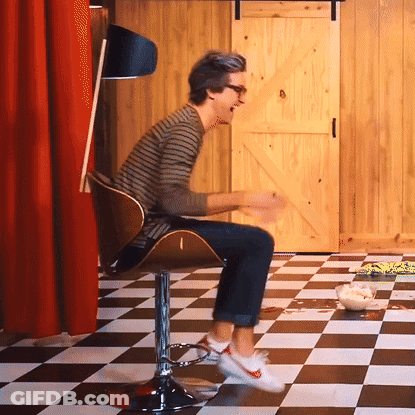 Man Sitting In Checkerboard Floor GIF