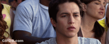 Man Sitting In Crowd Looking At Something GIF