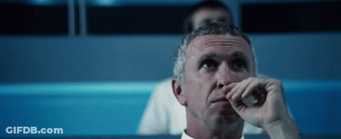 Man Sitting In Dark Room Hand To Nose GIF