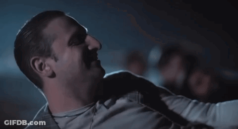 Man Sitting In Dark Room With Arm Around Shoulder GIF