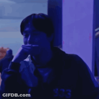Man Sitting In Dark Room With Blue Light GIF